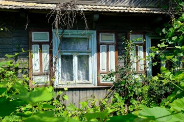 Beautiful wooden house with 
decorative shutters in the village, Podlasie, Poland. This area is called the Land of Open Shutters