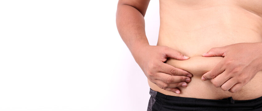 Close up of fatty Men's hand catching his fat belly  or Man's hand grabbing his fat on white background in studio With copy space.