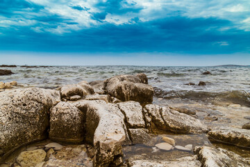 Rock formations on the Adriatic Sea in summer, under warm evening light