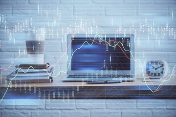 Financial graph colorful drawing and table with computer on background. Multi exposure. Concept of international markets.