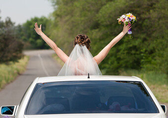 Happy moments. Bridegroom with hands to the sky out of open car celebration 