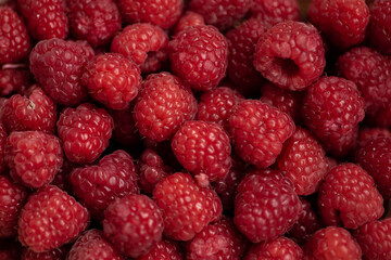 Raspberry background. Fresh large bright appetizing raspberries close up. Top view. Macro photo of raspberry.