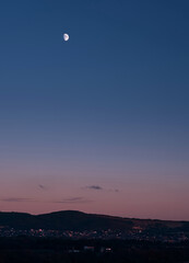 The beginning of the night, full moon over the village in the spurs of the Caucasus Mountains.