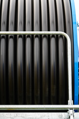 Obraz premium Rolled up of black irrigation hose