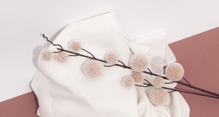 Stylish autumn winter flat lay composition. Textiles and flowers decor. Minimalist beige trendy colours