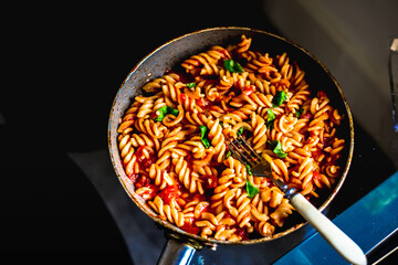 A high angle shot of delicious pasta with tomato sauce