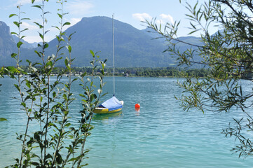 Austrian lake beautiful blue and green with single boat and ball