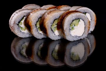 Fresh delicious beautiful sushi rolls on a dark background