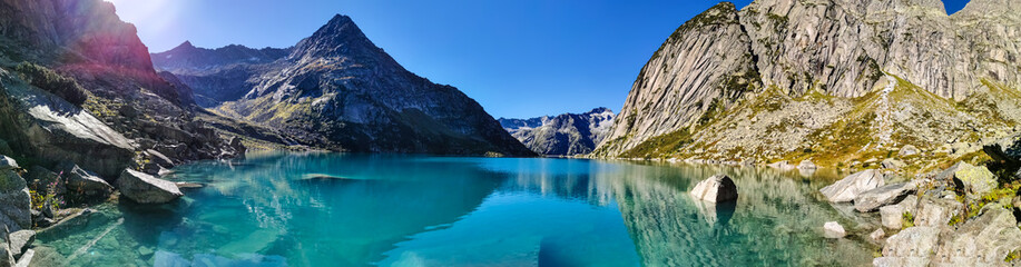 Fototapeta na wymiar Gelmersee. Dam in the Swiss alps for Hydro power. Clear Blue lake