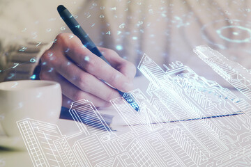 IOT drawing over writing hands in notepad background. Concept of smart home. Multi exposure