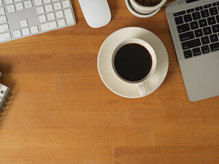 Female office worker working with digital tablet and stationery on wooden table