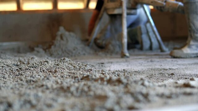 Concrete pump. Leveling sand and cement screed over floor heating