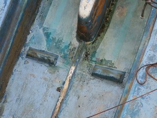 bottom of a blue polyester boat floating on water