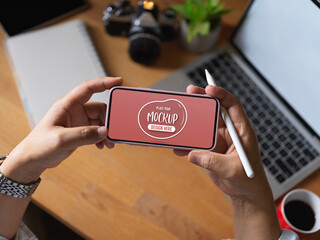 Male worker holding mock up horizontal smartphone screen