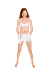 Fototapeta premium Cheerful young woman wearing a bath towel and a bandeau bra in front of white studio background