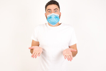 Puzzled and clueless young blond man with arms out, shrugging his shoulders, saying: who cares, so what, I don't know. Negative human emotions, facial expressions, life perception and attitude.