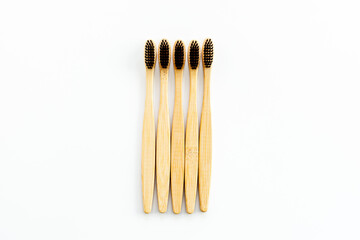 Eco materials concept with bamboo tooth brush on white background top view copy space