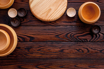 Making wooden dishes. Empty bowls on brown wooden background top view copy space