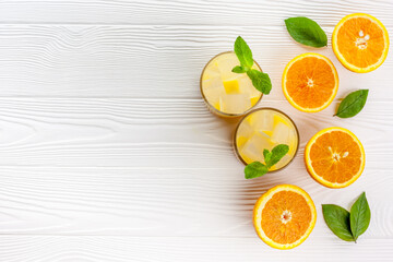 Summer drink from orange with ice on white wooden background top view flat lay copy space