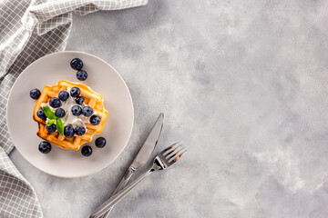 Breakfast Homemade belgian waffles on served table on gray marble background top view