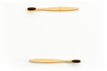 Eco materials concept with bamboo tooth brush on white background top view copy space