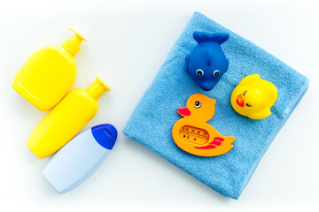 Bath cosmetics and Toy for child. Shampoo, gel, cream, soap and towel. White background top view