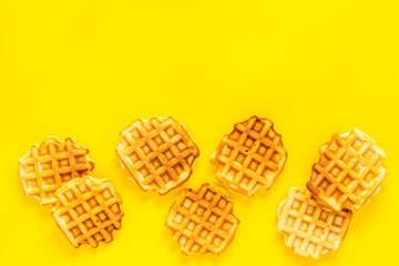 Traditional belgian waffles on yellow background top view mockup