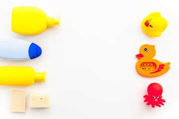 Bath cosmetics and Toy for child. Shampoo, gel, cream, soap and towel. White background top view
