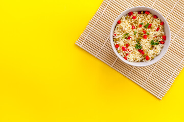 Instant noodle with pepper,peas, chopstick and tower. Yellow background top view copy space