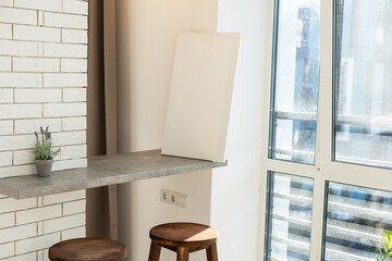 Blank white poster banner standing in the apartment. Mock up template for present business concept.