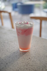 Strawberry milkshake on top of a table from several angle