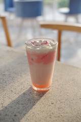 Strawberry milkshake on top of a table from several angle