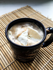 a cup of coffee on a wooden stand