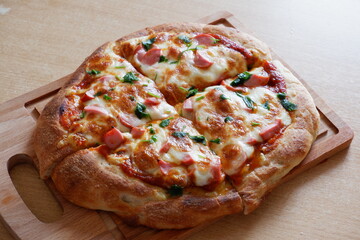 pizza on a wooden tray on the table