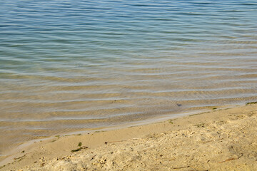 Fototapeta na wymiar Sandy shore lake