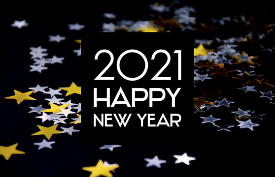 2021 Happy New Year black background frame with golden stars stock images. 2021 New Year sign on a starry background. Happy New Year 2021 with golden and silver shiny stars greeting card images