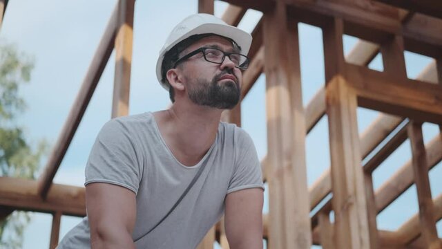 Home construction: designer engineer on building structure background