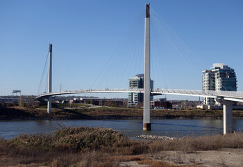 The Bob Kerrey Pedestrian Bridge crosses over the river, connecting Omaha, Nebraska with Council Bluffs, Iowa