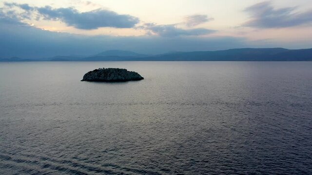 A small island in front of Vlychos Plakes Beach in Hydra Island, Greece