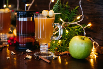 Autumn tea in french press and citrus tea in transparent mug with apple, feijoa and lychee on the table in restaurant