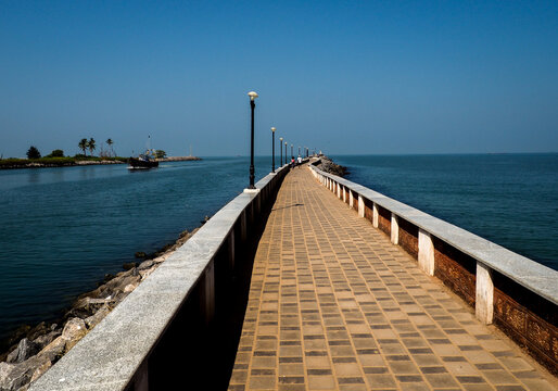 Long and beautiful almost neverending pier pointing to the sea. Malpe, Karnataka, India.
