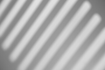 Obraz premium Shadow overlay effect. Shadows of window frames, bars and lines on the wall in sunlight. Soft sunshine