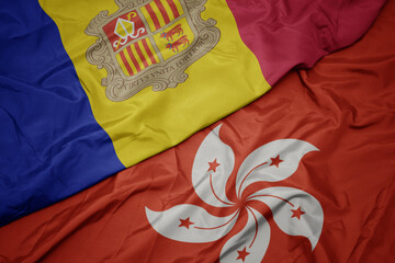 waving colorful flag of hong kong and national flag of andorra.