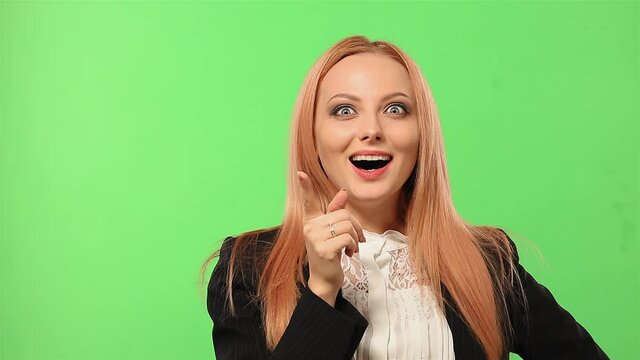 Business of the change agrees with the ingenious idea. Gesture of consent against an isolated background. Girl in the suit shows her finger. High quality FullHD footage.