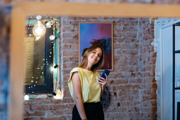 Portrait of young beautiful girl in yellow t-shirt posing in photography studio.