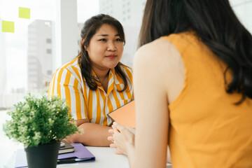 Chubby woman dealing with partner in office room.