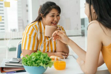 Chubby woman enjoy eating healthy food for lunch with friend.