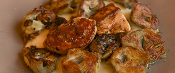 Roasted artichokes with foie served with a delicious white sauce