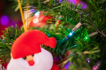 Decorated Christmas light on fir tree New Year holidays background