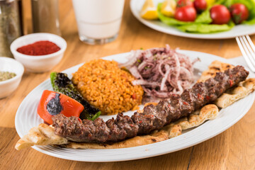 Turkish Adana Kebab with Vegetables on wooden table